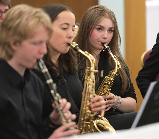 Members of the College Jazz band playing saxophone