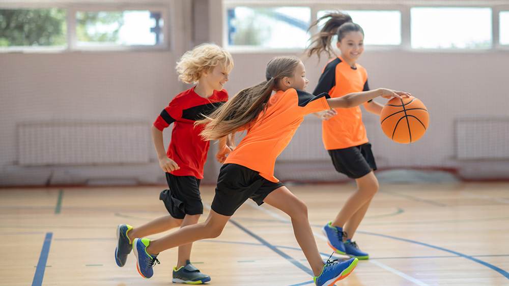 Children playing football indoors