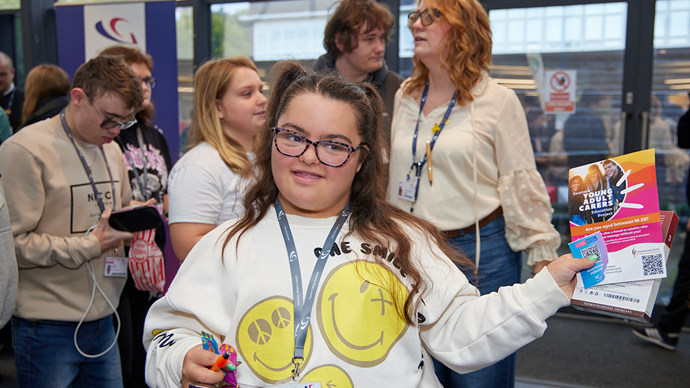 Student at fayre with leaflets