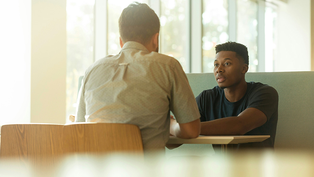 Person talking to another in a professional setting