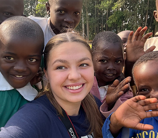 Student takes selfie with a group of Madungu school pupils