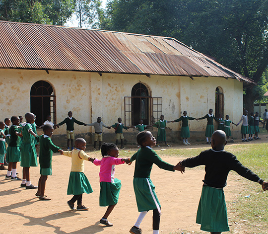 Madungu pupils holding hands in school playground