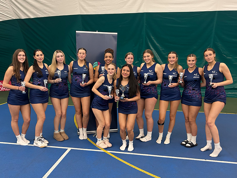 Netball Academy team with trophies