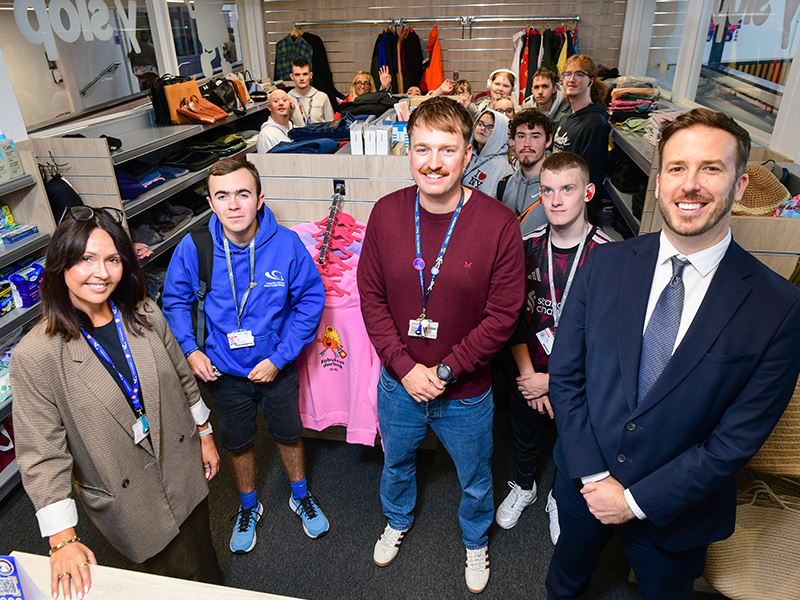 Group photo of staff and students inside the shop
