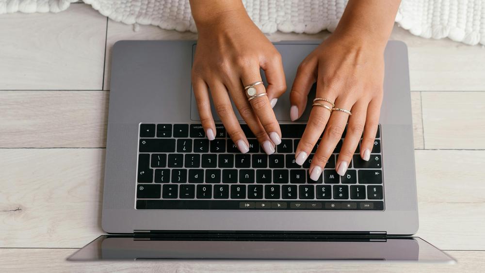 two students in lab coats in a laboratory