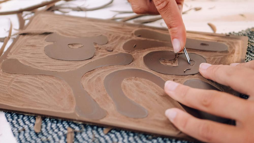 close up of person carving into lino