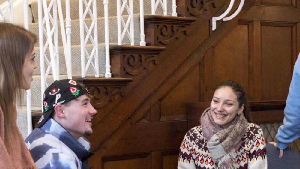 two students in lab coats in a laboratory
