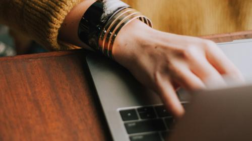 A person typing on a laptop.