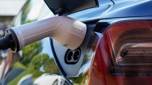 An electric vehicle charging at an electric vehicle charging point. 