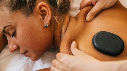 Person receiving hot stone massage