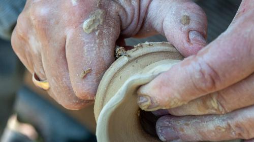  Close up of person working with clay