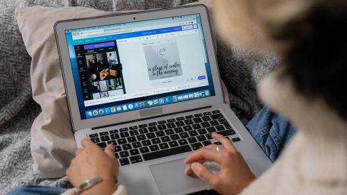 Student on a laptop using Canva