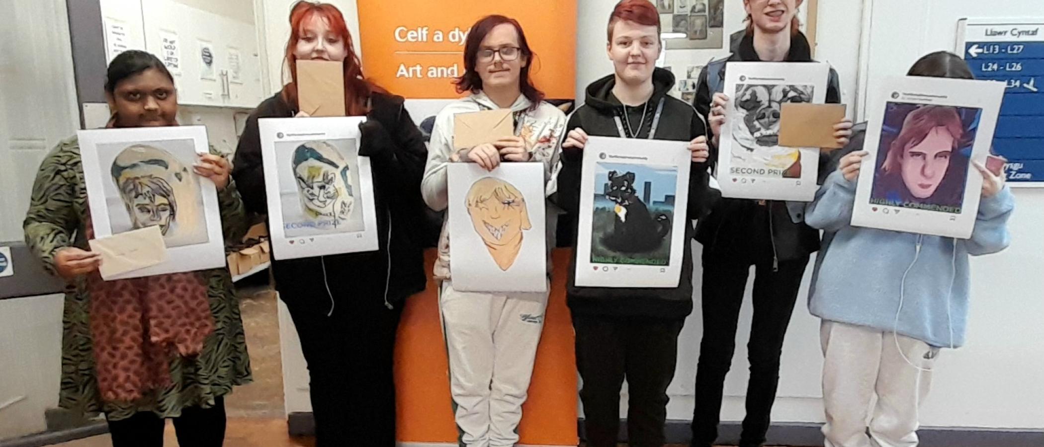 Six of the winning learners, holding up their portraits