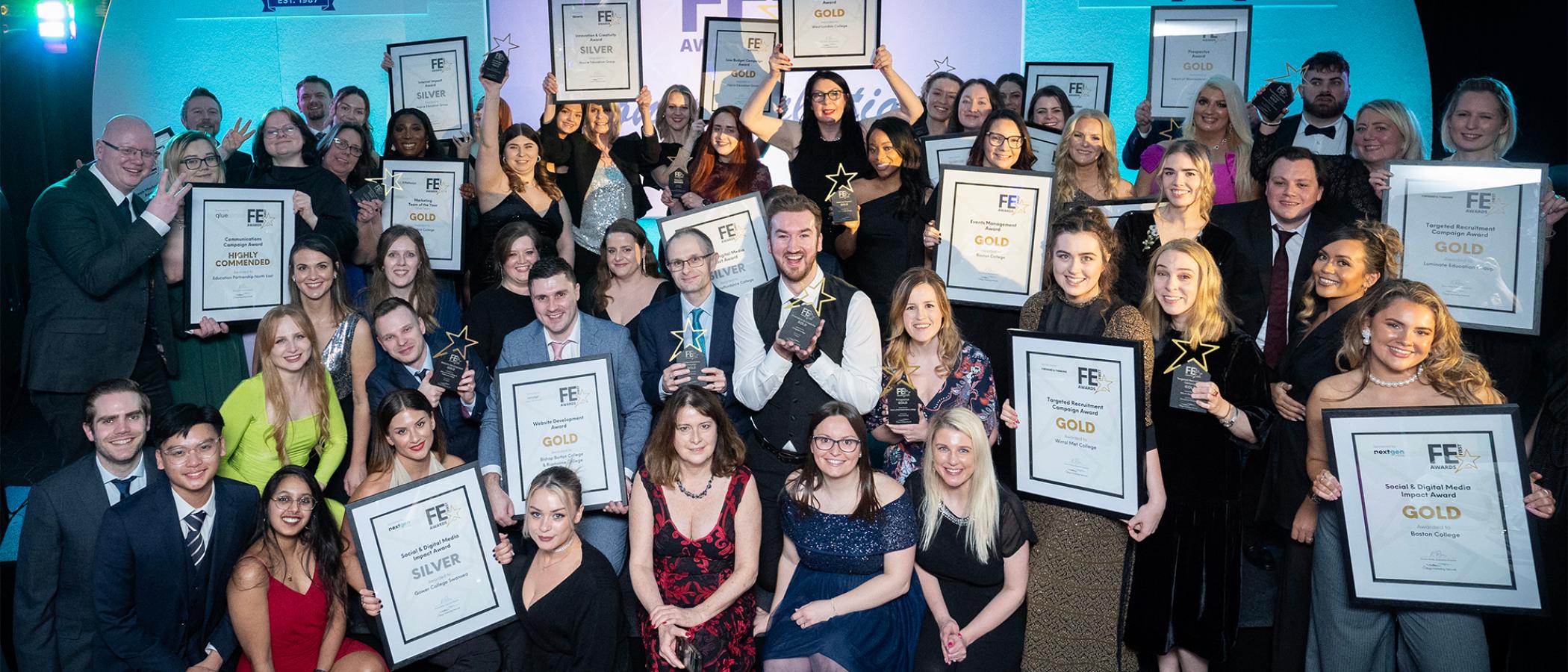 A big group of people smiling and holding certifcates