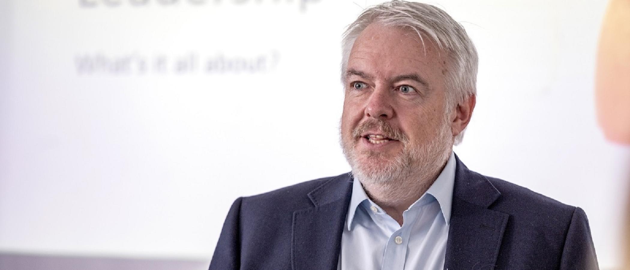 Man talking, wearing shirt and jacket