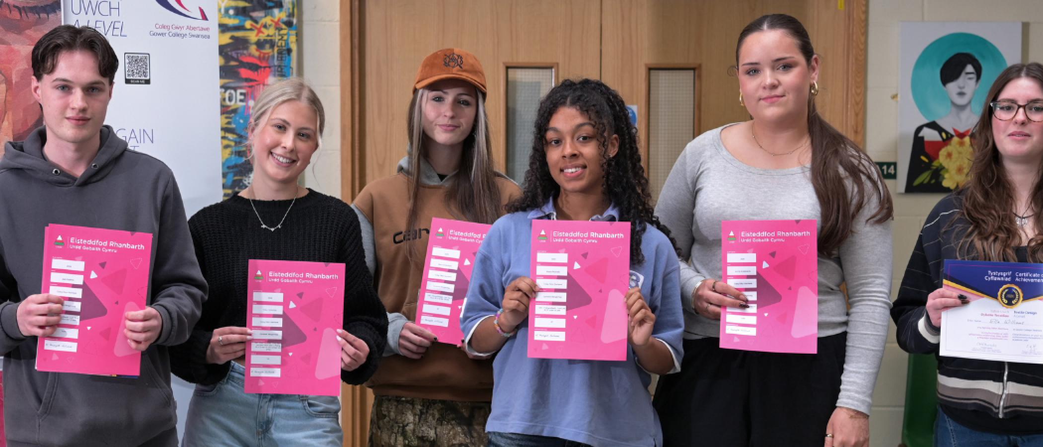 Award winning students stand with their certificates 