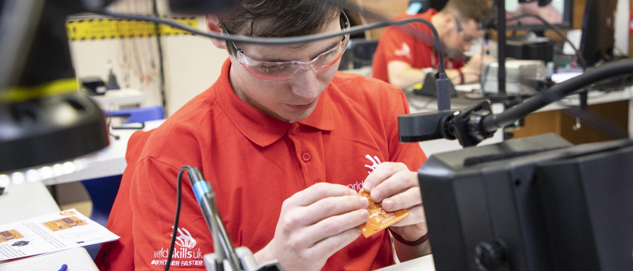 Liam Hughes and Ben Lewis, who won joint Silver, placing components onto circuit boards and soldering as part of the competition