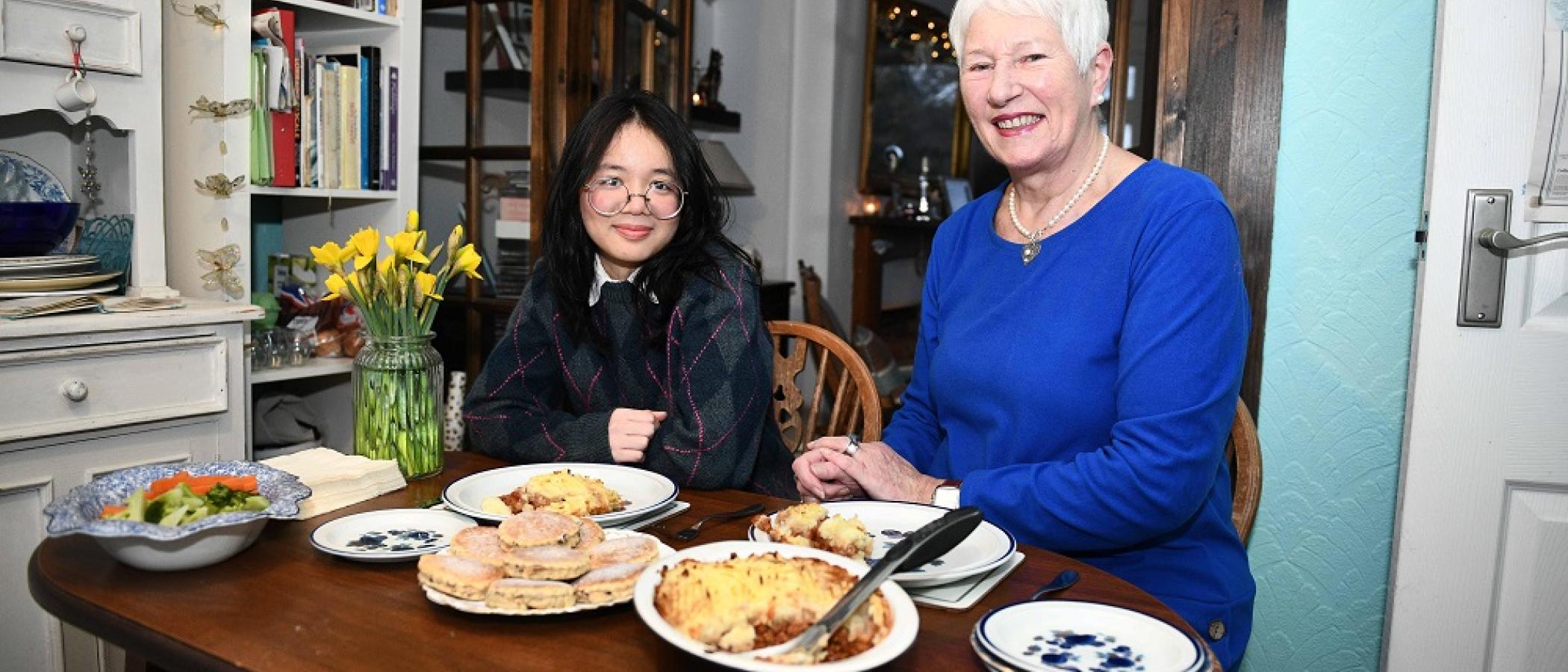 Sue Morris and Nguyen Nghi having dinner at the table
