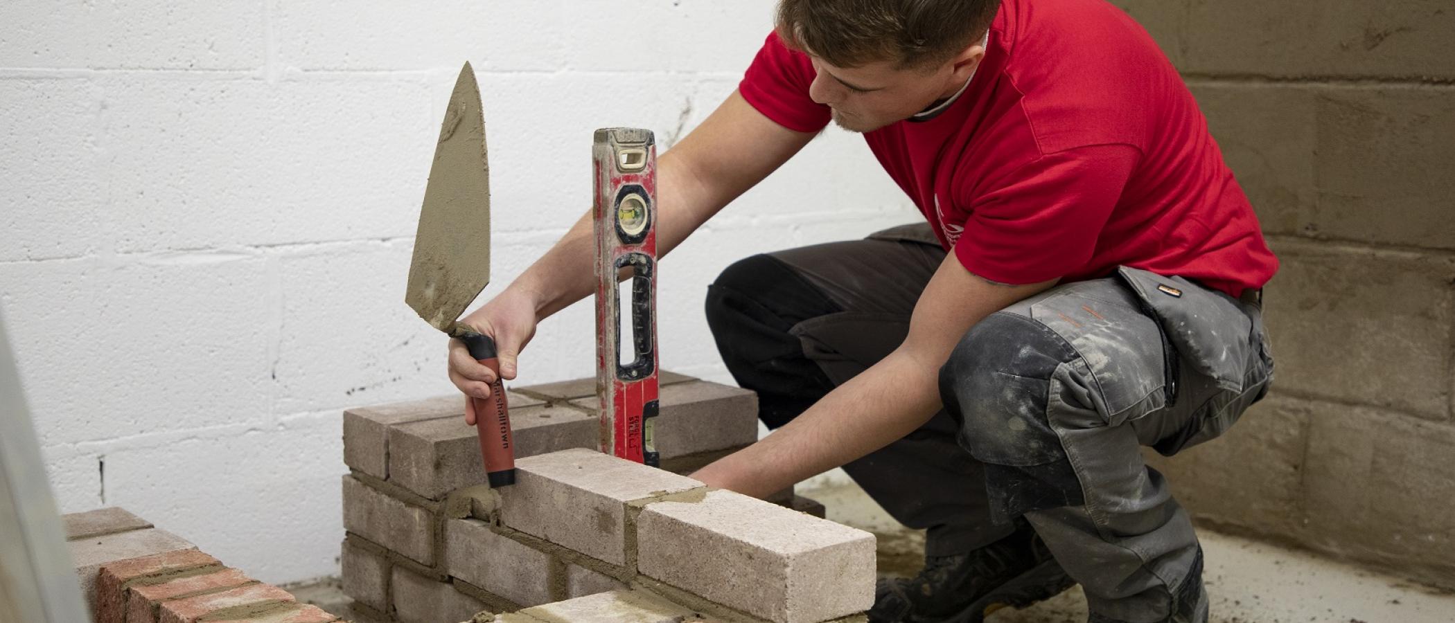A Built Environment learner building a wall during Skills Competition Wales