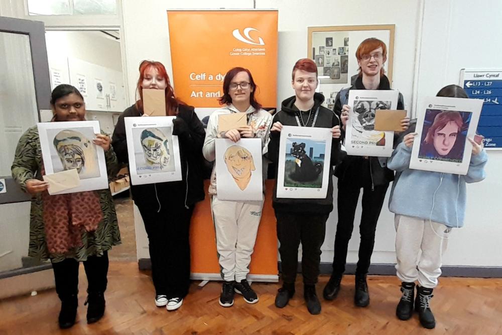 Six of the winning learners, holding up their portraits