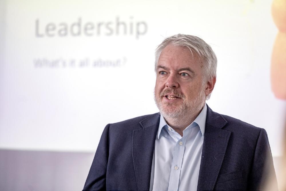 Man talking, wearing shirt and jacket