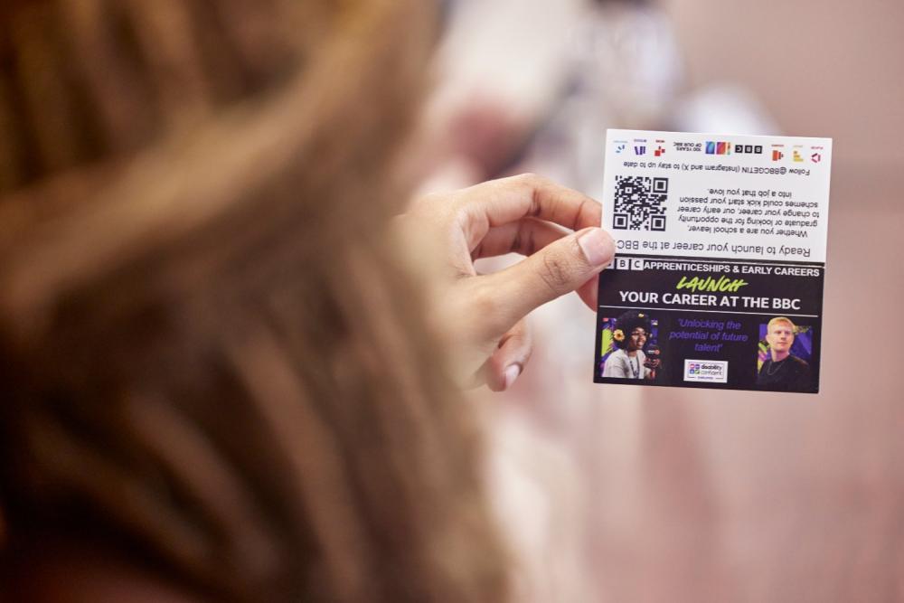 Student holds business card