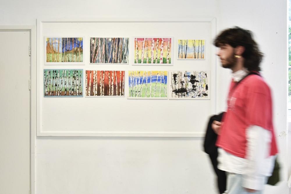 Art on the wall, with person passing