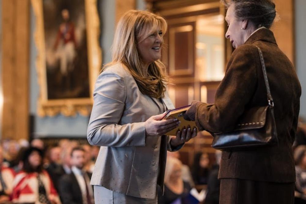 Sarah King receiving award from Princess Anne