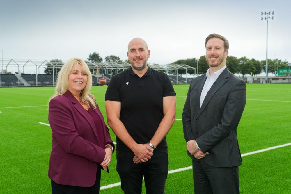 Gower College Swansea CEO Kelly Fountain, Principal Paul Kift and Ospreys Managing Director (Business) Richard Lancaster mark the launch of the new rugby partnership at St Helen's 