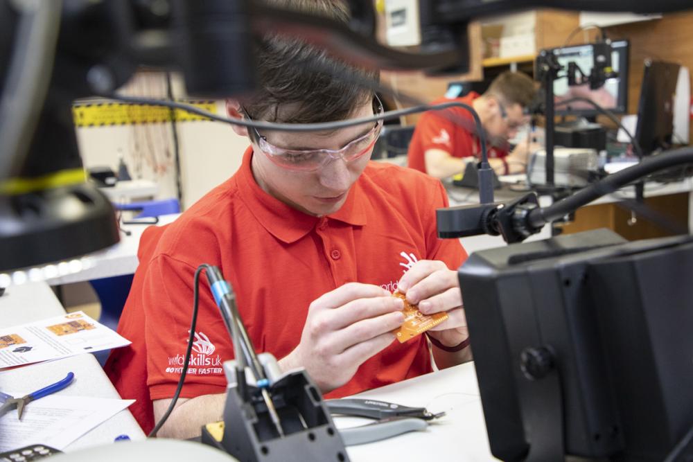 Liam Hughes and Ben Lewis, who won joint Silver, placing components onto circuit boards and soldering as part of the competition