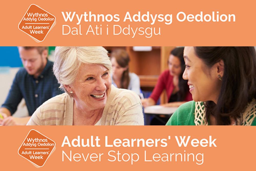 Adult learners in a classroom with the Adult Learners Week logo with "Wythnos Addys Oedolion - Dal Ati i Ddysgu" at the top and "Adult Learners' Week - Never Stop Learning" at the bottom.