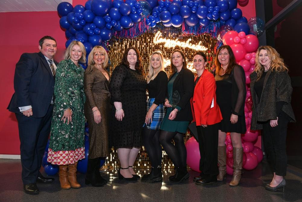 Housing team posing in front of balloons backdrop at Apprenticeship Awards 2023