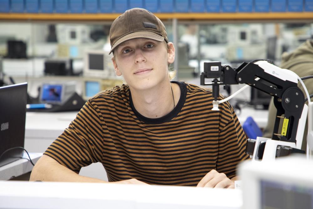 Scott Tavner sitting at desk with electronic equipment.