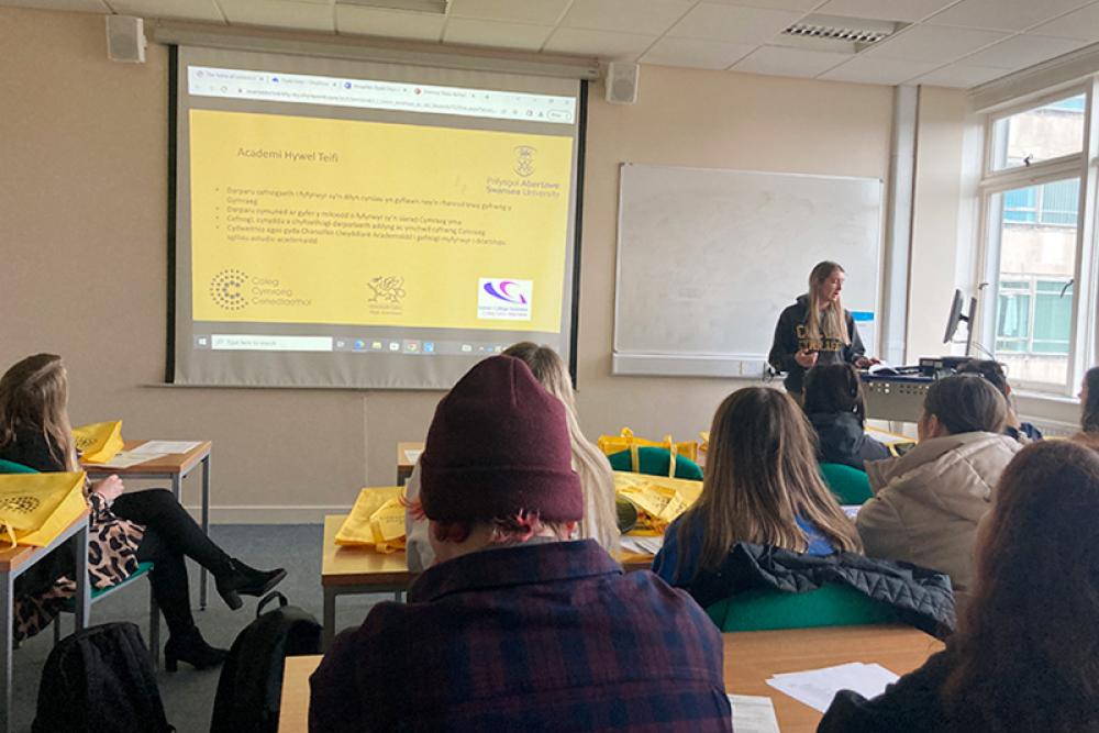 Learners sitting at table learning midwifery with dolls