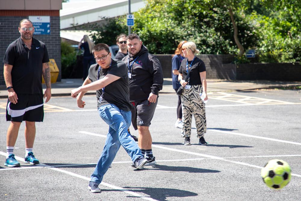 Staff play football darts