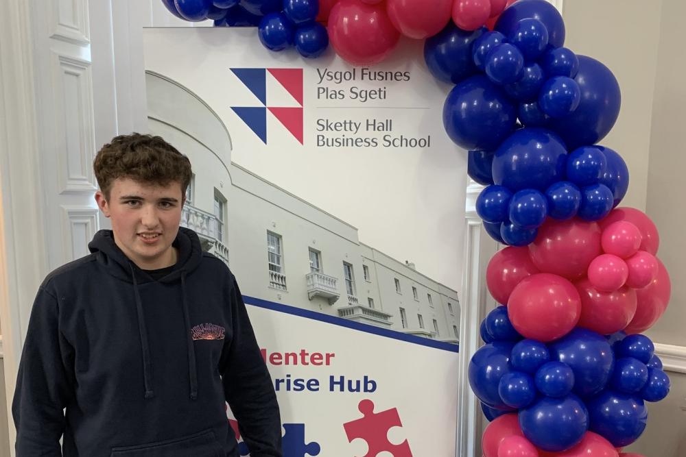 Student standing with balloons
